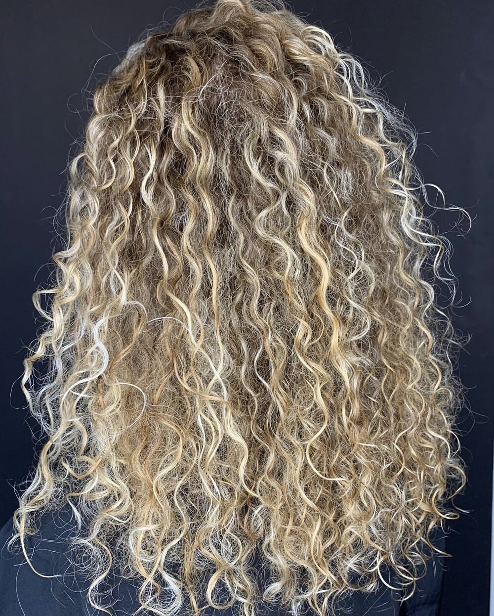 Blonde curly highlights by Red Market New York colorist Saudy Lara